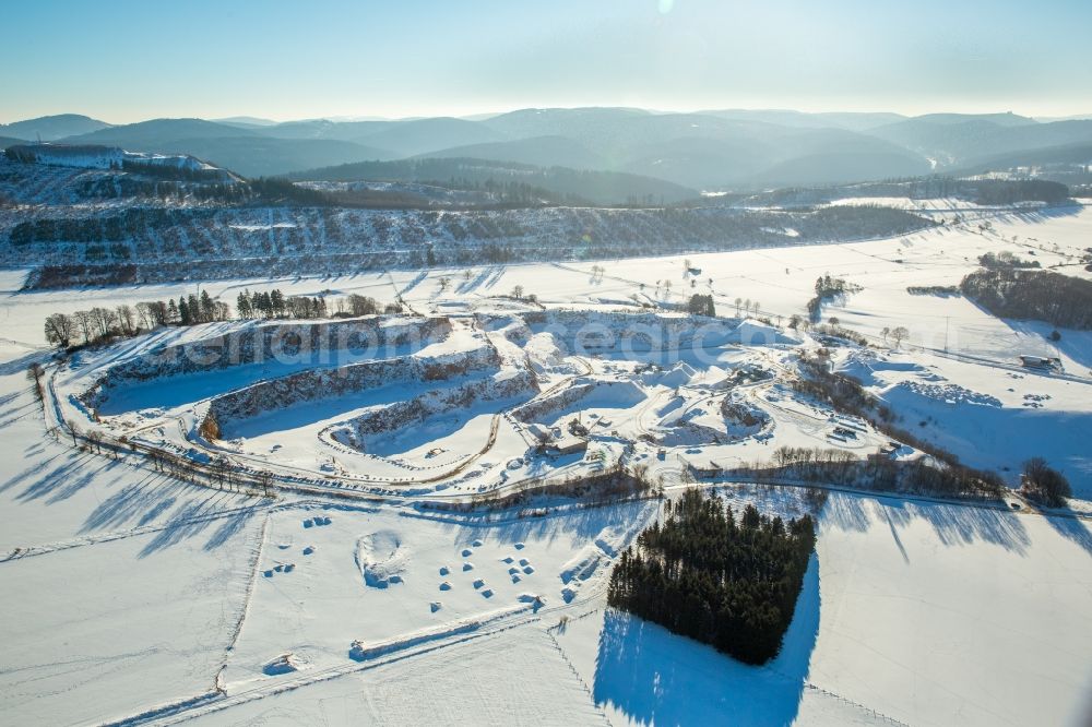 Aerial image Brilon - Wintry snowy stone quarry in the B 251 in Brilon in the federal state North Rhine-Westphalia