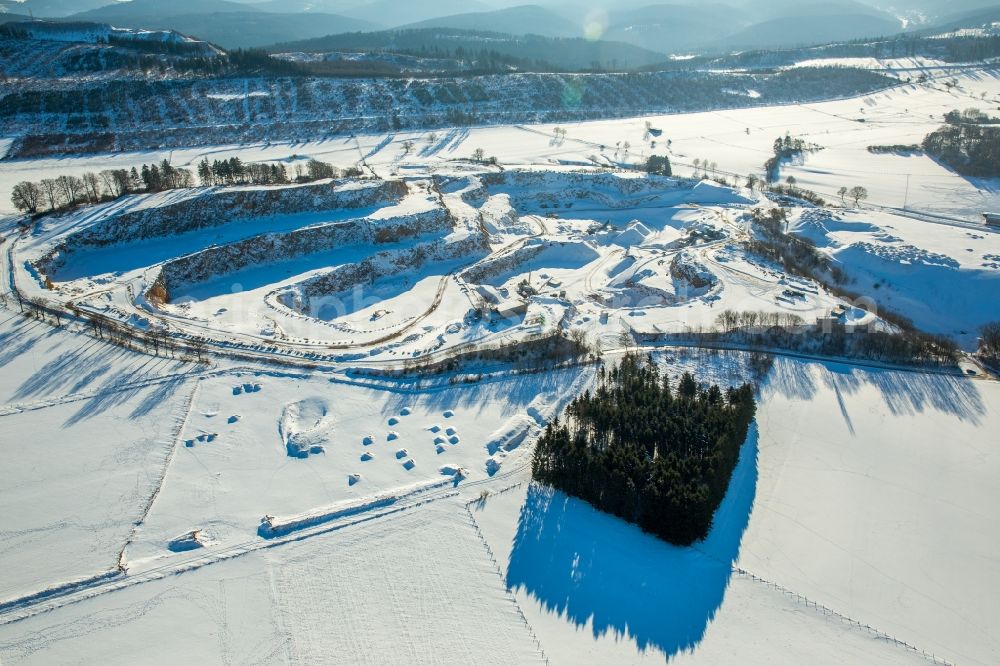 Aerial photograph Brilon - Wintry snowy stone quarry in the B 251 in Brilon in the federal state North Rhine-Westphalia