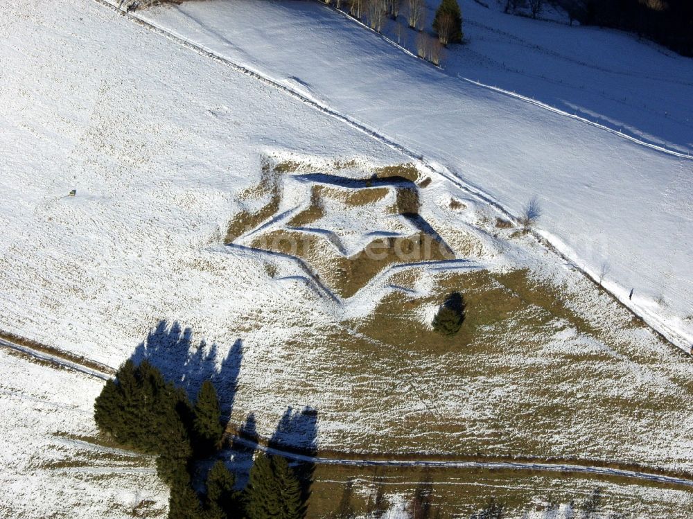 Kleines Wiesental from above - Like a Christmas star, the wintry snowy star shaped remains of the fortifications in the Black Forest in the district Neuenweg in Kleines Wiesental in the state of Baden-Wuerttemberg