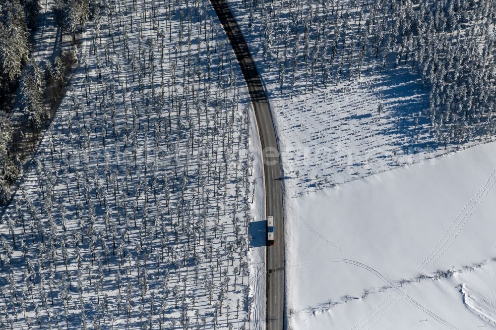 Altlastenberg from the bird's eye view: Wintry snowy street - road guidance of Hochsauerland Hoehenstrasse in Altastenberg at Sauerland in the state North Rhine-Westphalia, Germany