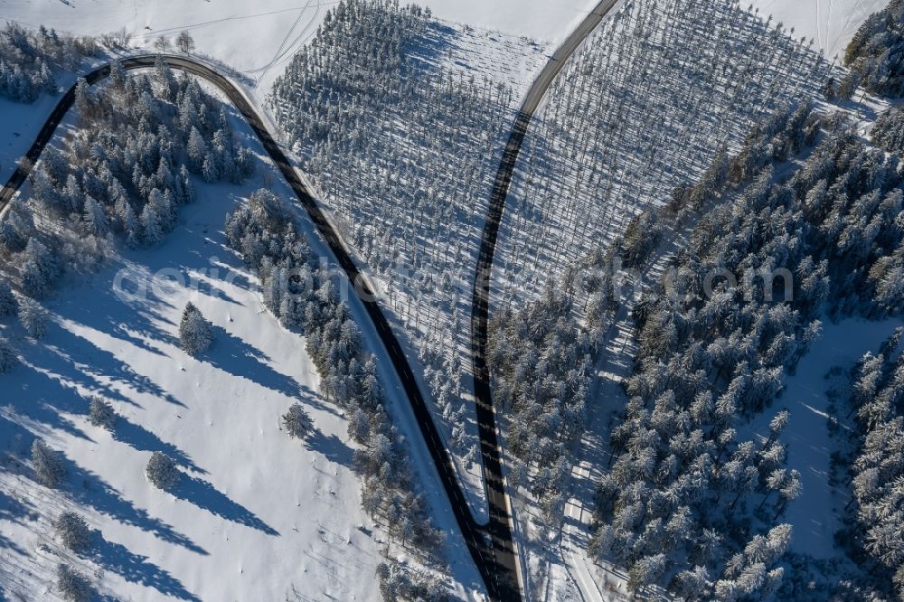 Altlastenberg from above - Wintry snowy street - road guidance of Hochsauerland Hoehenstrasse and the L540 road in Altastenberg at Sauerland in the state North Rhine-Westphalia, Germany