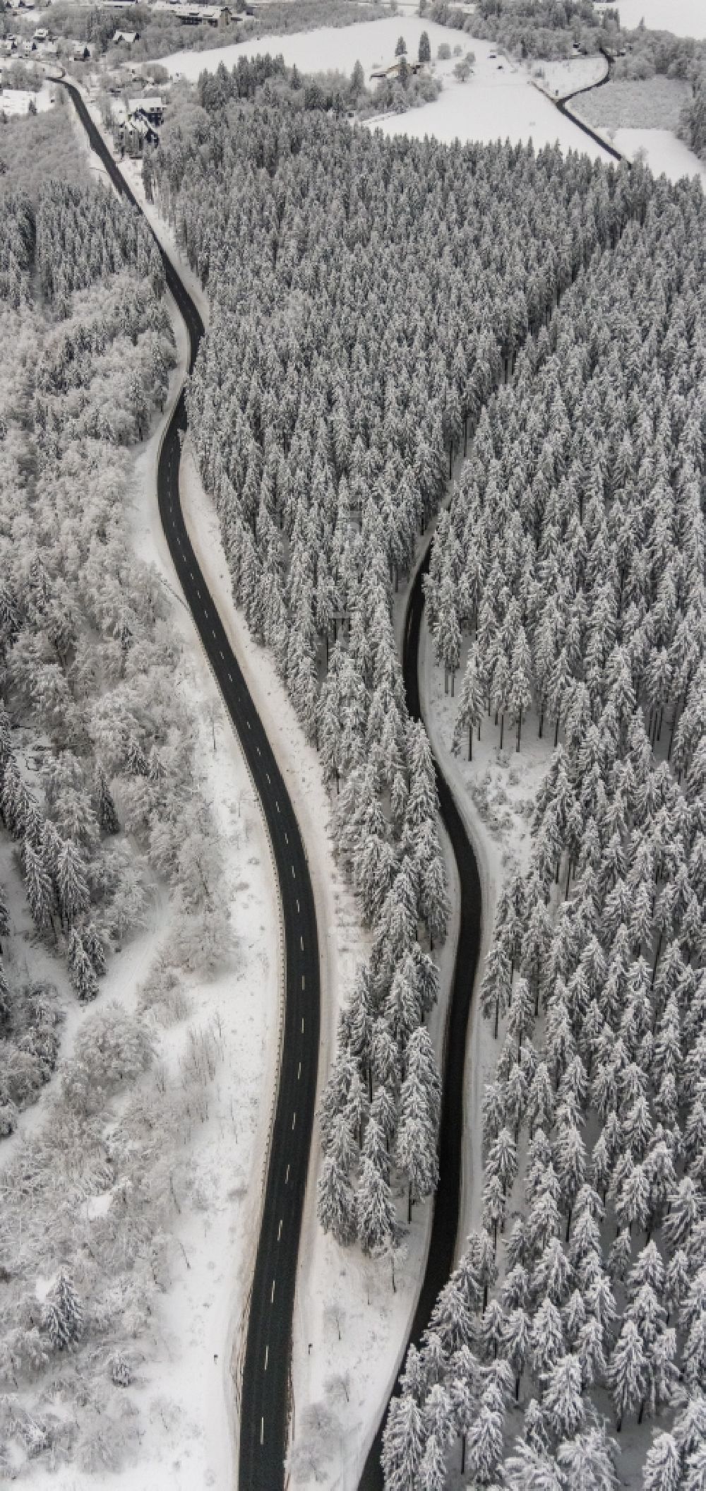 Winterberg from above - Wintry snowy street - road guidance Winterberger Strasse and Rothaarsteig in Winterberg at Sauerland in the state North Rhine-Westphalia, Germany