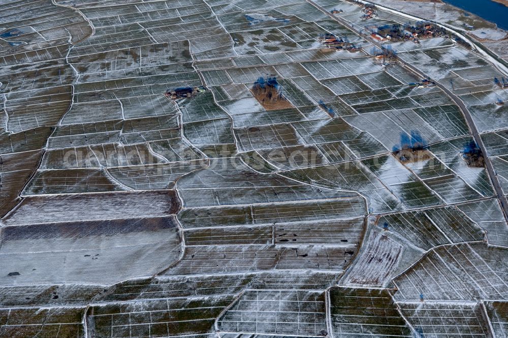 Bunderhee from the bird's eye view: Wintry snowy structures on agricultural fields in Bunderhee in the state Lower Saxony, Germany