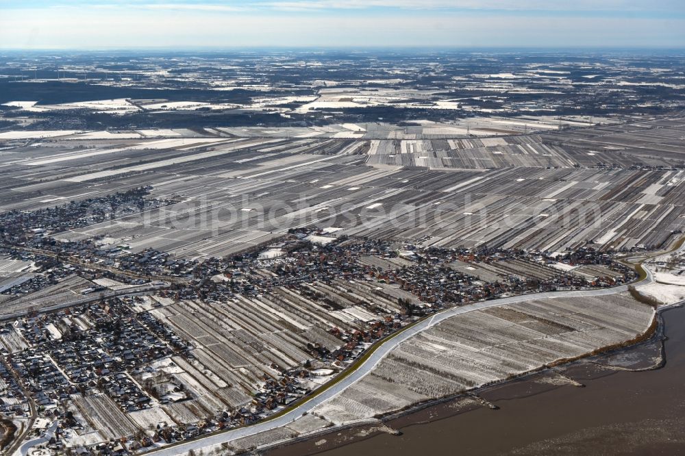 Aerial image Grünendeich - Wintry snowy structures on agricultural fields in Gruenendeich in the state Lower Saxony, Germany