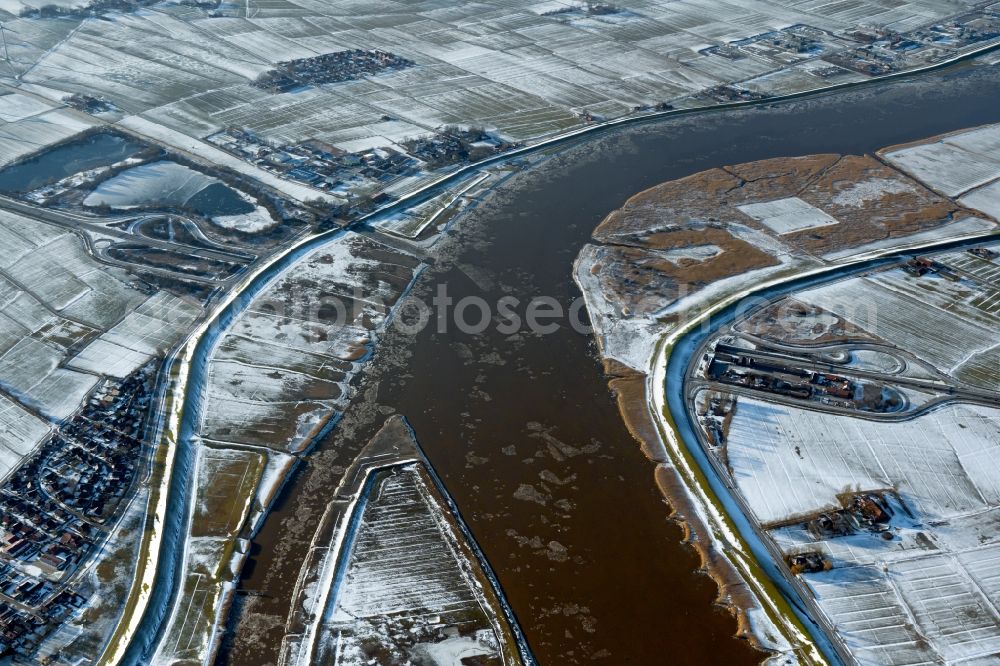 Aerial image Jemgum - Wintry snowy curved loop of the riparian zones on the course of the river Ems in Jemgum in the state Lower Saxony, Germany