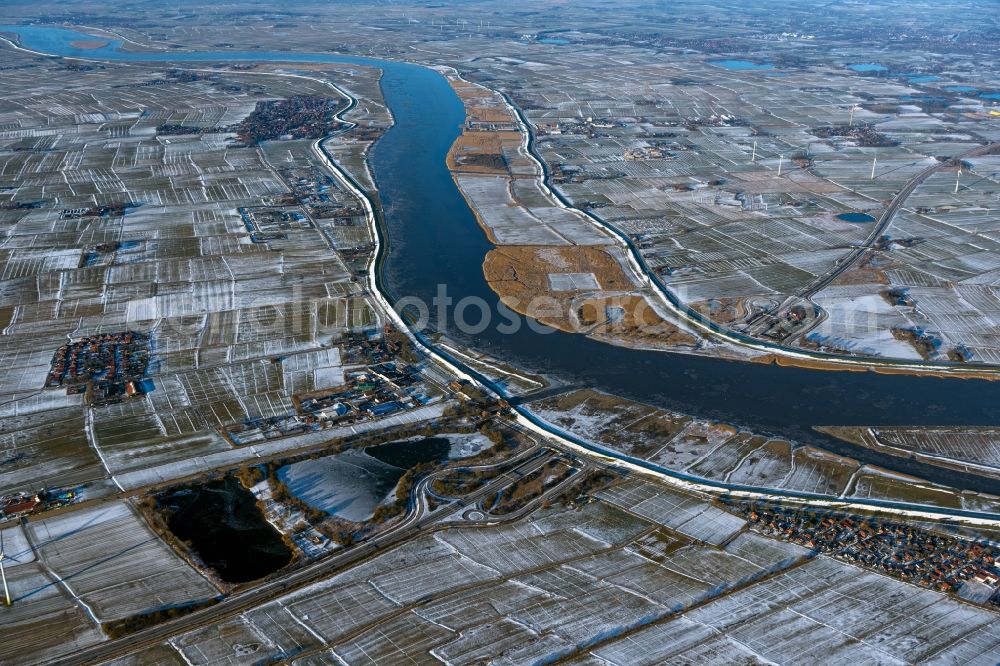 Jemgum from above - Wintry snowy curved loop of the riparian zones on the course of the river Ems in Jemgum in the state Lower Saxony, Germany