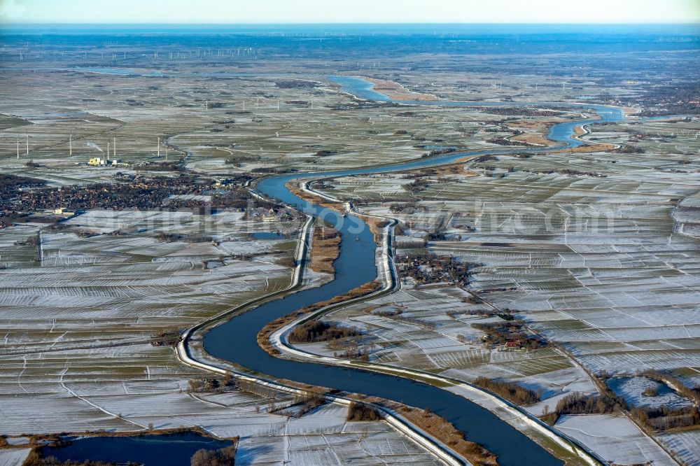 Westoverledingen from above - Wintry snowy curved loop of the riparian zones on the course of the river of Ems in Westoverledingen in the state Lower Saxony, Germany