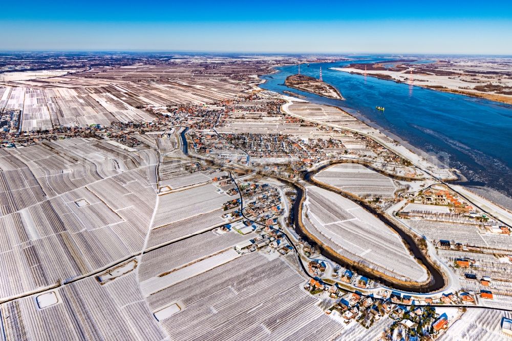 Grünendeich from above - Wintry snowy curved loop of the riparian zones on the course of the river Luehe in the district Luehe in Jork Old Land in the state Lower Saxony, Germany