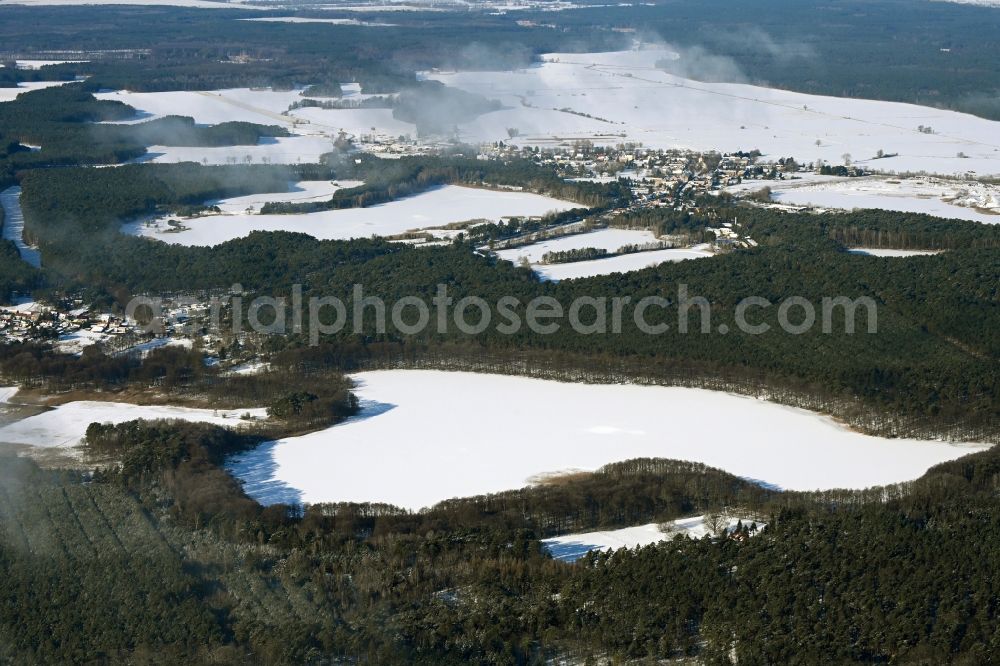 Aerial image Biesenthal - Wintry snowy riparian areas on the lake area of Bukowsee in a forest area in Biesenthal in the state Brandenburg, Germany