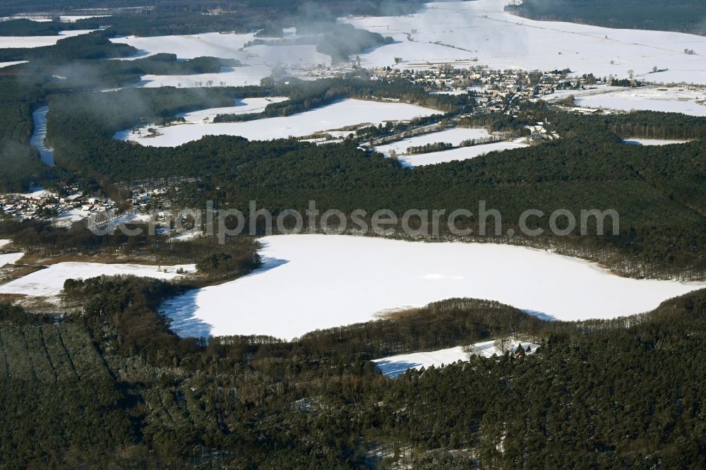 Aerial photograph Biesenthal - Wintry snowy riparian areas on the lake area of Bukowsee in a forest area in Biesenthal in the state Brandenburg, Germany