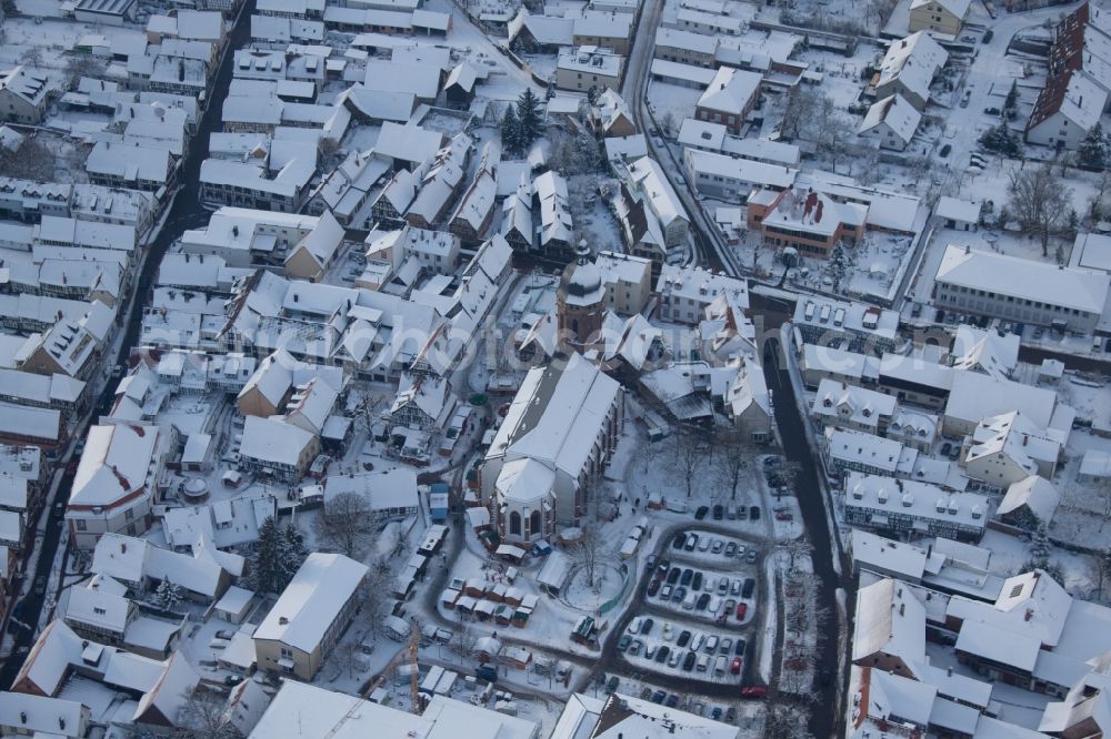 Aerial image Kandel - Wintry snowy Christmassy market event grounds and sale huts and booths on market place around tha church Sankt Georgskirche in Kandel in the state Rhineland-Palatinate, Germany