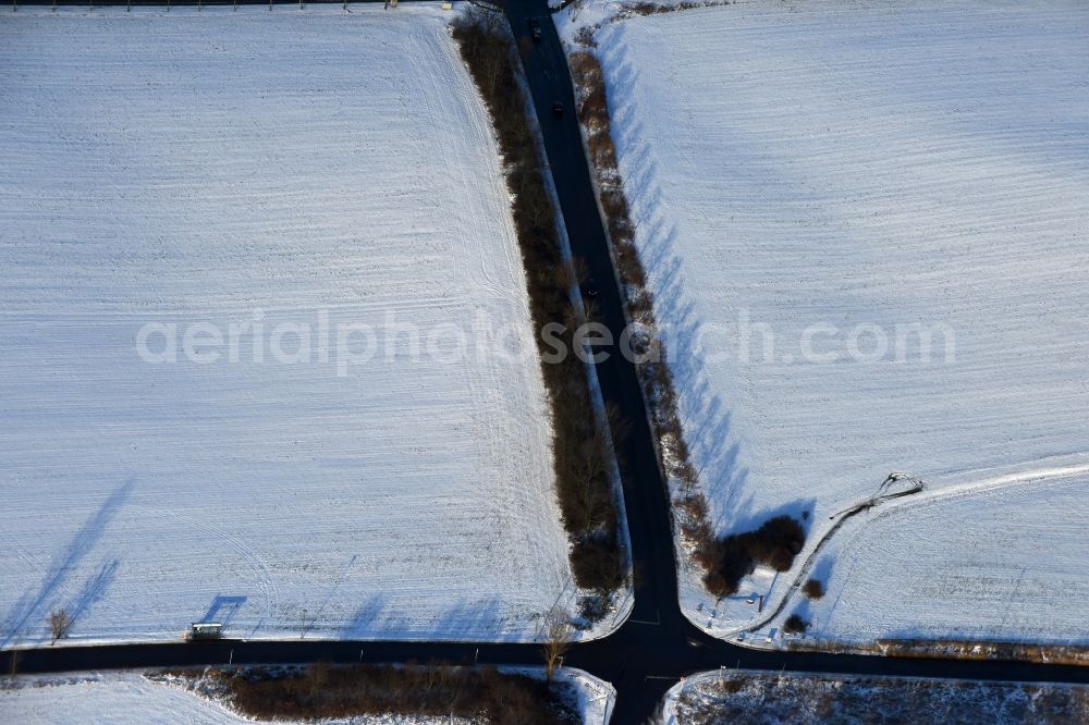 Aerial image Berlin - Wintry snowy Road over the crossroads Am Niederfeld - Elsenstrasse - Kressenweg in the district Bezirk Marzahn-Hellersdorf in Berlin