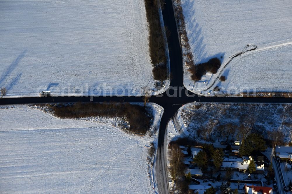 Berlin from above - Wintry snowy Road over the crossroads Am Niederfeld - Elsenstrasse - Kressenweg in the district Bezirk Marzahn-Hellersdorf in Berlin