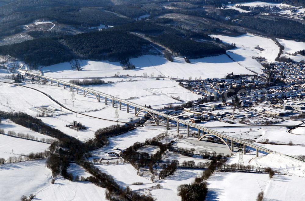 Ilmenau from above - Wintry snowy Viaduct of the railway bridge structure to route the railway tracks in Ilmenau in the state Thuringia, Germany