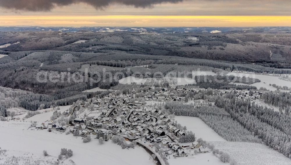 Aerial image Altastenberg - Wintry snowy surrounded by forest and forest areas center of the streets and houses and residential areas in Altastenberg at Sauerland in the state North Rhine-Westphalia, Germany