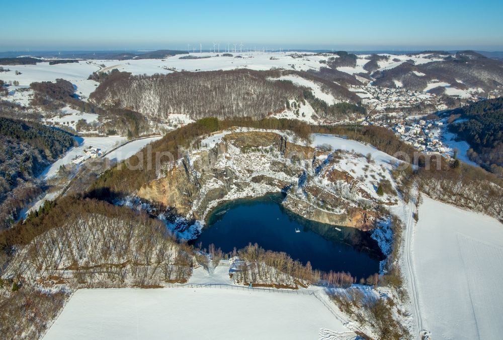 Aerial photograph Brilon - Wintry snowy woodland in the lake in the mountain / Messinghausener lake in Brilon in the federal state North Rhine-Westphalia