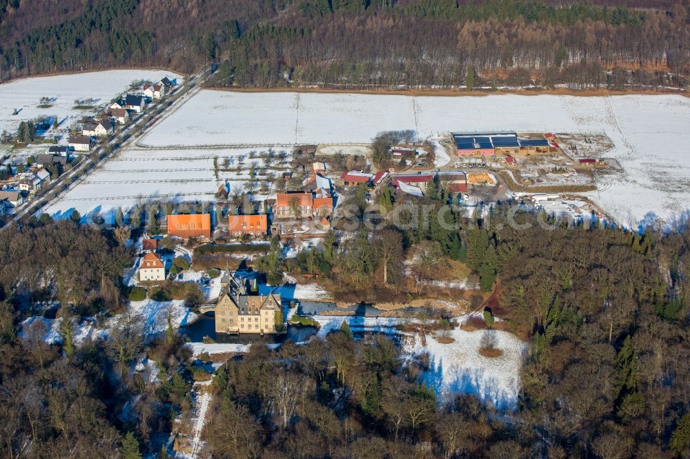 Neheim from above - Wintry snowy building and castle park systems of water castle Hoellinghofen in Neheim in the state North Rhine-Westphalia