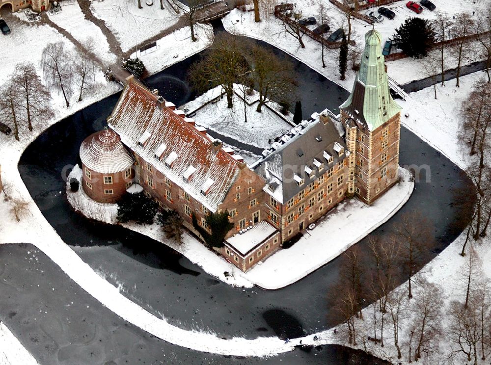 Raesfeld from above - Wintry snowy building and castle park systems of water castle in Raesfeld in the state North Rhine-Westphalia, Germany