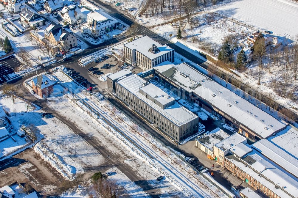 Brilon from the bird's eye view: Wintry snowy Building and production halls on the premises of HOPPECKE Batterien GmbH & Co. KG in the district Hoppecke in Brilon in the state North Rhine-Westphalia