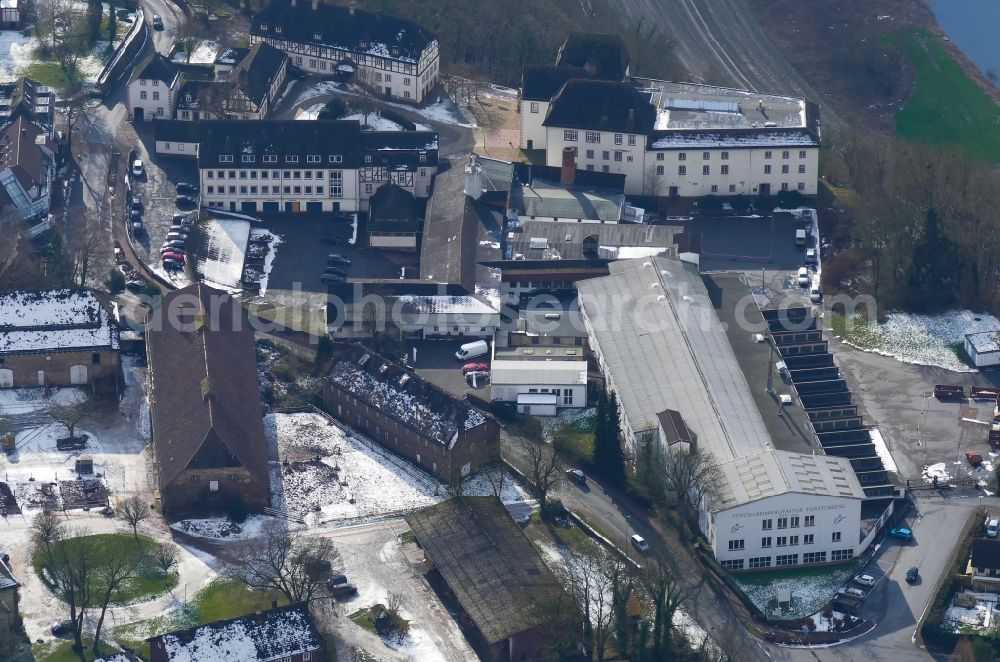 Fürstenberg from above - Wintry snowy Building and production halls on the premises of Porzellanmanufaktur Fuerstenberg in Fuerstenberg in the state Lower Saxony, Germany