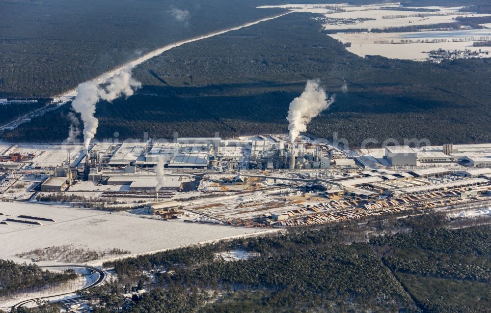 Aerial image Baruth/Mark - Wintry snowy Buildings and production halls on the factory premises for wood processing of Binder Beteiligungs AG in Baruth/Mark in the state of Brandenburg, Germany