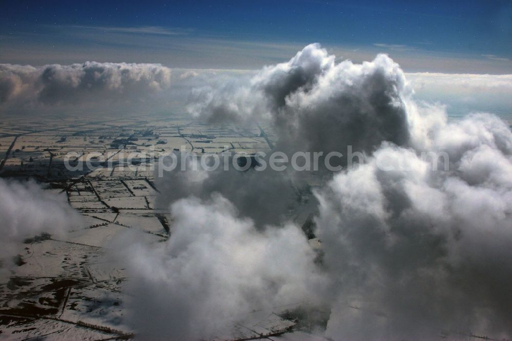 Aerial image Fehrbellin - Wintry snowy weather conditions with cloud formation - on blue Sky in Fehrbellin in the state Brandenburg