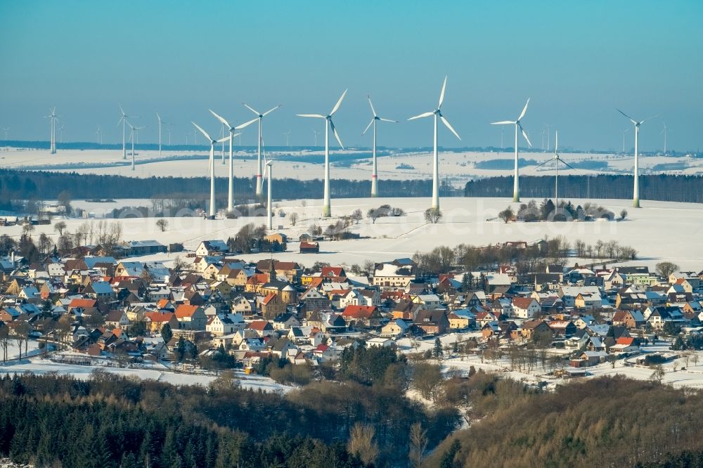 Aerial image Marsberg - Wintry snowy Wind turbine windmills on a field in Marsberg in the state North Rhine-Westphalia