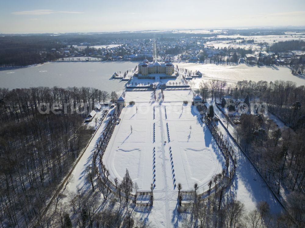 Moritzburg from above - Wintry snowy winterly snow-covered hunting and moated castle and castle park in the castle pond in Moritzburg in the federal state of Saxony, Germany