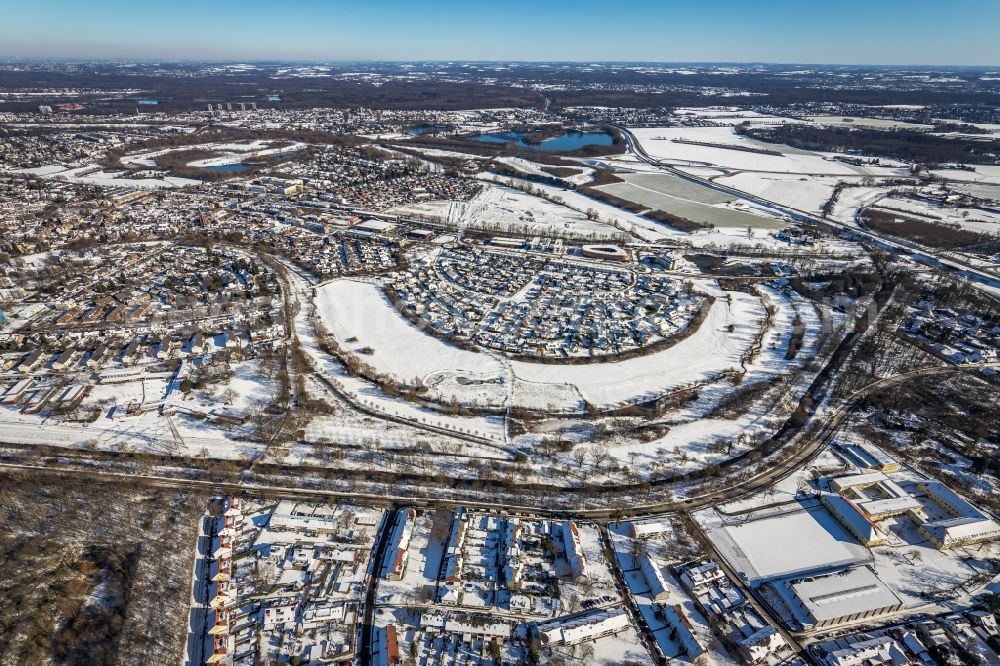 Duisburg from the bird's eye view: Wintry snowy single-family residential area of settlement along the Heinz-Troekes-Strasse - Johannes-Molzahn-Strasse overlooking the office buildings of the Infineon Technologies AG and the Xella International GmbH in Duisburg at Ruhrgebiet in the state North Rhine-Westphalia, Germany