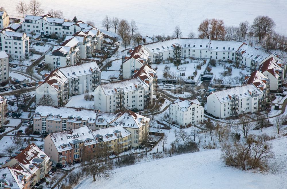 Bernau from above - Wintry snowy residential area of the multi-family house settlement along the Pegasusstrasse in Bernau in the state Brandenburg, Germany