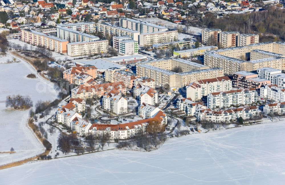 Bernau from the bird's eye view: Wintry snowy residential area of the multi-family house settlement on Pegasusstrasse in Bernau in the state Brandenburg, Germany