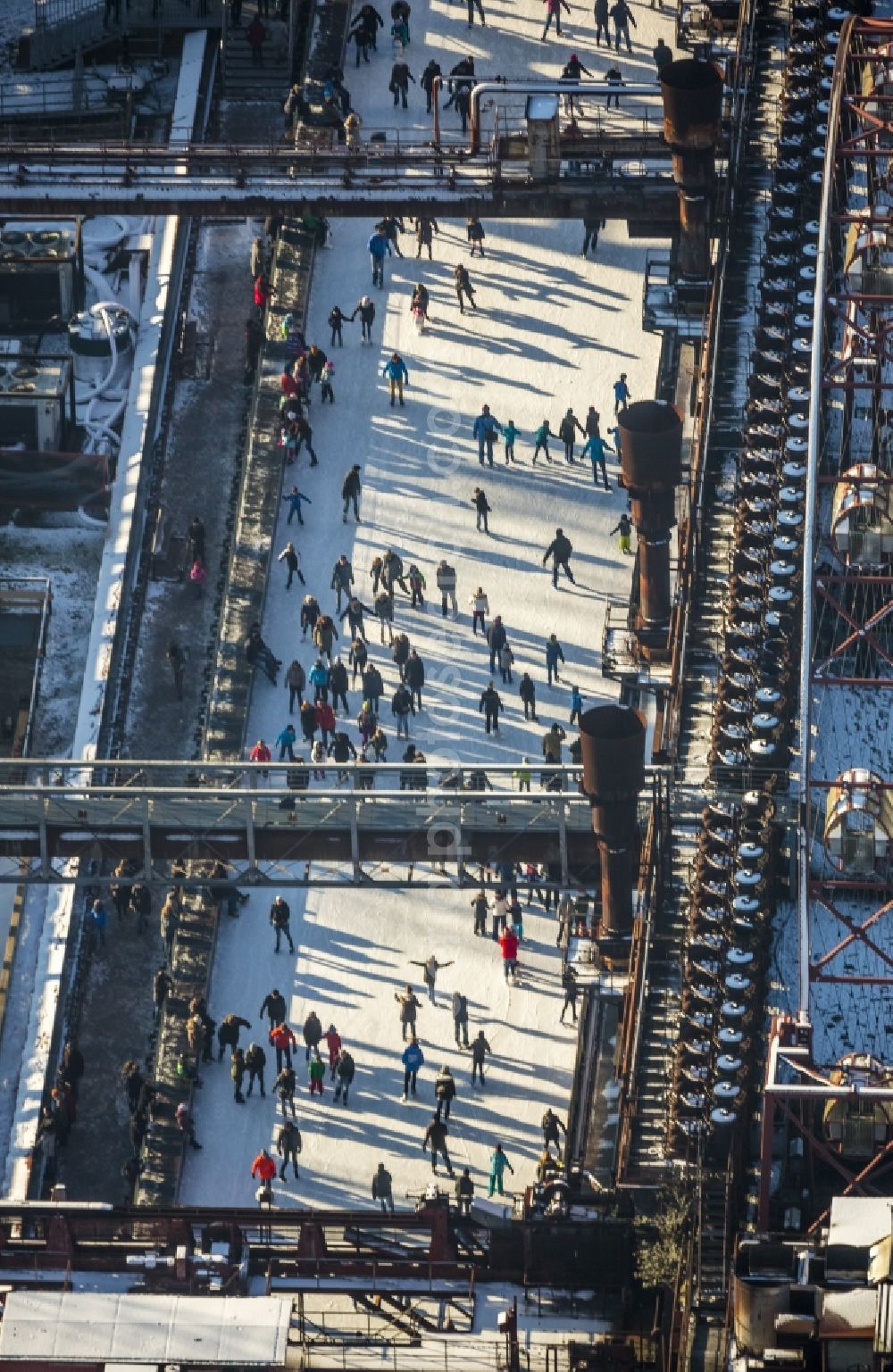 Essen from the bird's eye view: Winter walk on the ice rink in the coking plant Zeche Zollverein in Essen in North Rhine-Westphalia