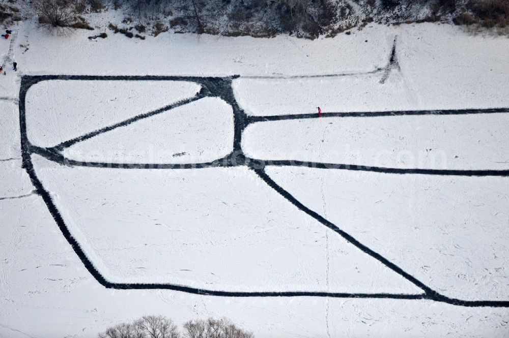 Berlin from above - Winter sports with skating on the lake in Berlin Biesdorf. Ice skating is once again become a national pastime