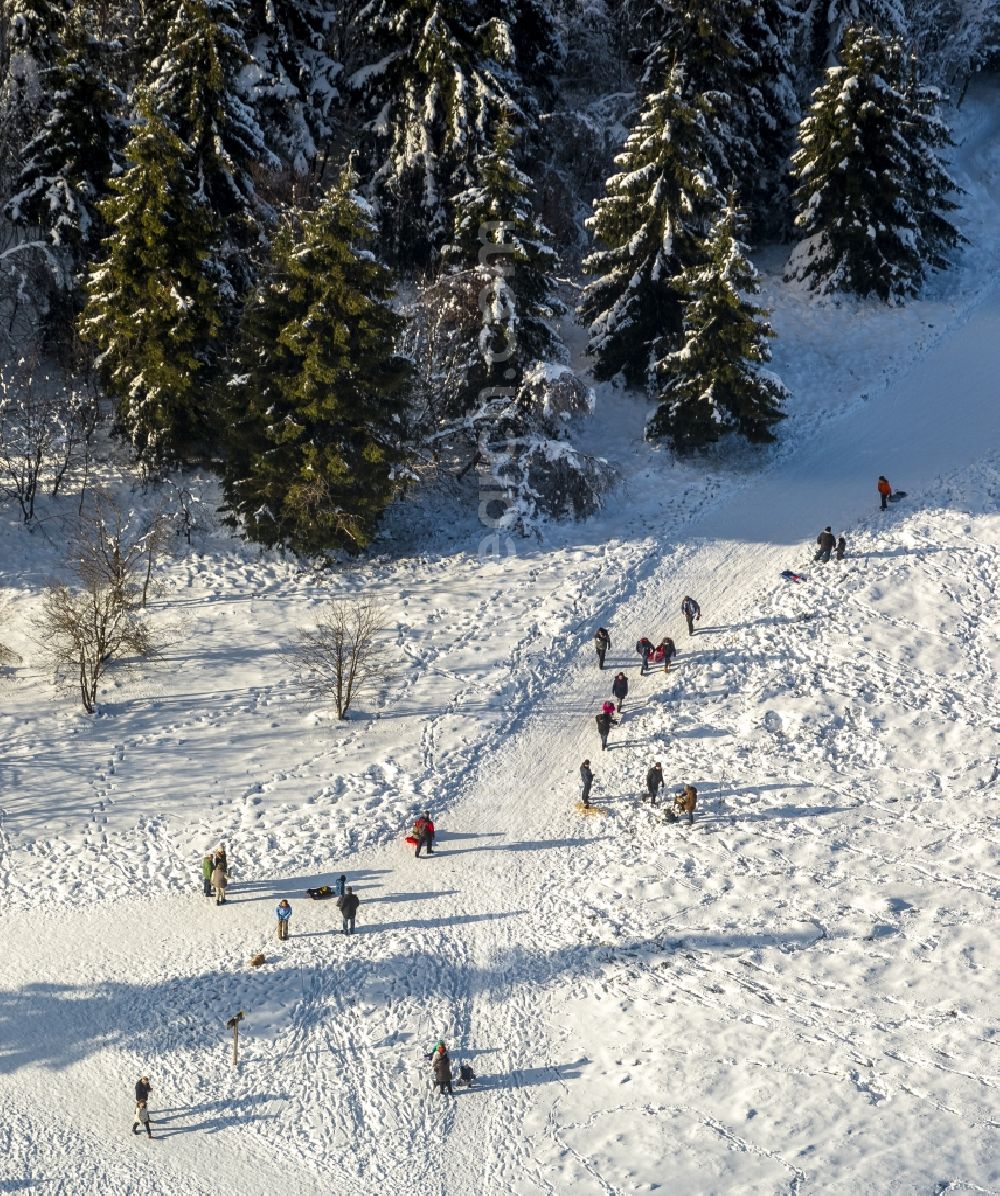 Aerial image Winterberg - Winter - View of the snow-covered ski trails of the winter sports area Skiliftkarussell Winterberg with mountain station and ski lift at Kahler Asten near by Winterberg in the state of North Rhine-Westphalia