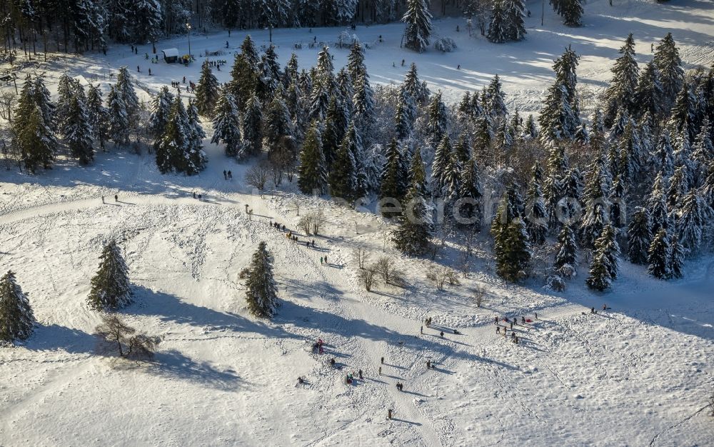 Winterberg from above - Winter - View of the snow-covered ski trails of the winter sports area Skiliftkarussell Winterberg with mountain station and ski lift at Kahler Asten near by Winterberg in the state of North Rhine-Westphalia