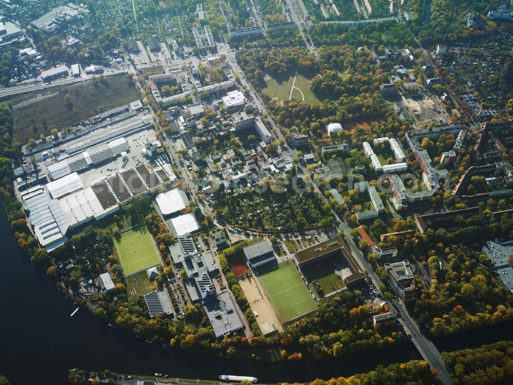 Berlin from above - Residential and commercial area with a school in the Neukoelln part of Berlin in Germany. The area is located in the North of the Britz part of the district on the shores of Teltow Canal and Harbour Britz East. The sports facilities belong to Otto-Hahn-School and the OZIMST institute