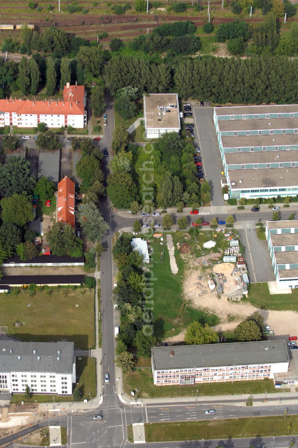 Aerial photograph Berlin - Blick auf das Wohn- und Industriegebiet an der Bahntrasse Niederschöneweide im Bereich der Landfliegerstrasse, Pilotenstraße, Hagedornstraße und Groß-Berliner Damm. Eine Immobilie der HVB Immobilien AG