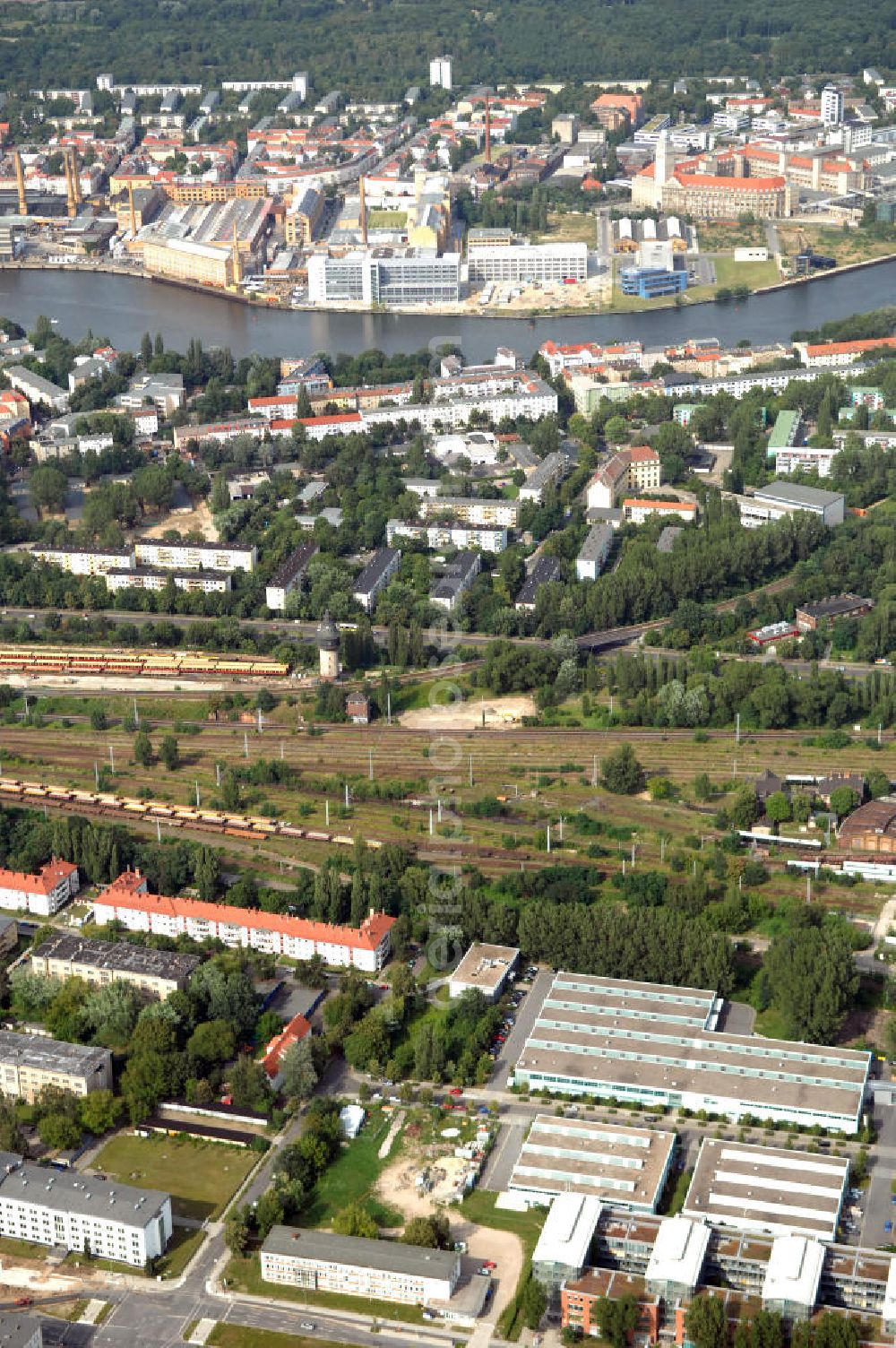 Aerial image Berlin - Blick auf das Wohn- und Industriegebiet an der Bahntrasse Niederschöneweide im Bereich der Landfliegerstrasse, Pilotenstraße, Hagedornstraße und Groß-Berliner Damm. Eine Immobilie der HVB Immobilien AG