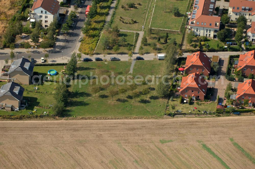 Berlin from the bird's eye view: Blick auf eine Grünfläche / Parkanlage zwischen Einfamilienhäuser und Mehrfamilienhäuser bzw. Reihenhäuser am Ingwäonenweg Ecke Achillesstraße in Karow.