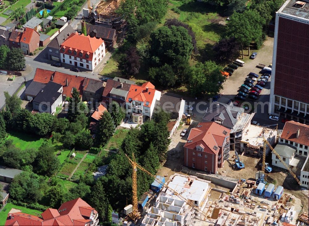 Rheinberg from the bird's eye view: View of construction works for a residential area and the former warehouse highrise of the spirits company Underberg Kraeuterturm in Rheinberg in the state North Rhine-Westphalia. The skyscraper at Kamper Strasse is landmarked as an industrial monument and is today being remodeled as as four-star Atlanta Hotel by the A.Real Estate GmbH