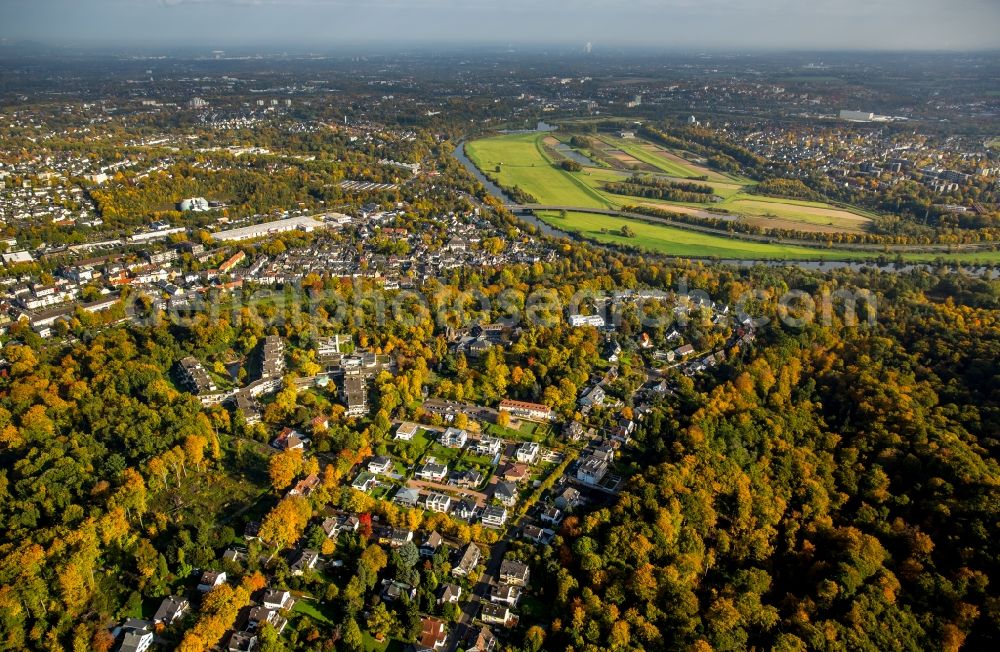 Rellinghausen from the bird's eye view: Single-family residential area of settlement in an autumnal forest in Rellinghausen in the state of North Rhine-Westphalia. The river Ruhr takes its course in the background, Essen is located in the North