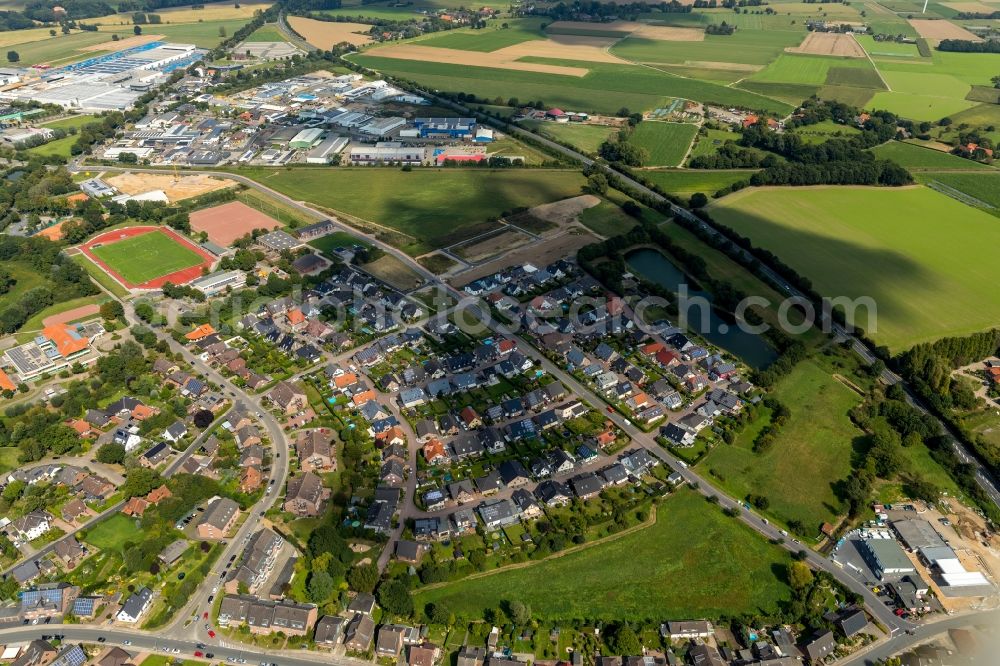 Aerial photograph Alpen - Single-family residential area of settlement along the Von-Dornik-Strasse in Alpen in the state North Rhine-Westphalia, Germany. With a view of the business district at the Weseler Str. And the soccer field of the FC Viktoria alps 1911 e.V.