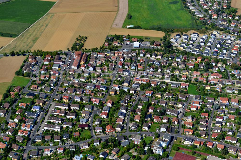 Estenfeld from above - Single-family residential area of settlement on the edge of agricultural fields in Estenfeld in the state Bavaria, Germany