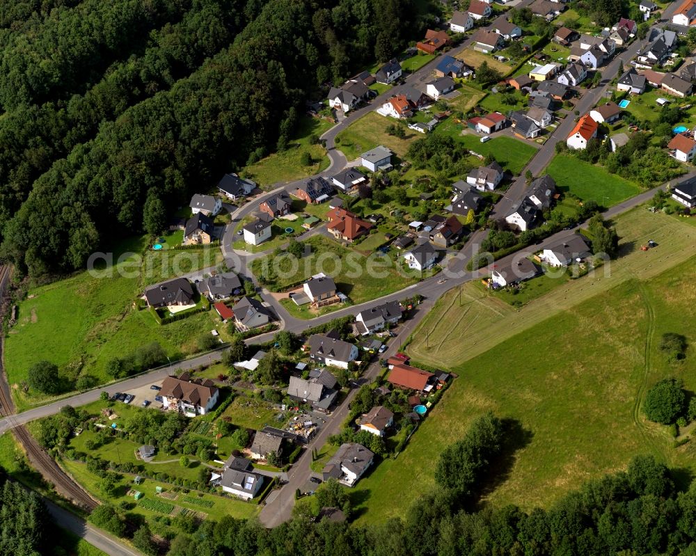 Steinebach from above - View of a residential area with single family houses in Steinebach in the state of Rhineland-Palatinate. Steinebach is located in a valley of the river Sieg. It is an official tourist resort. Steinebach consists of residential areas and a business park. It is home to the mining pit Bindweide and the Westerwald Museum