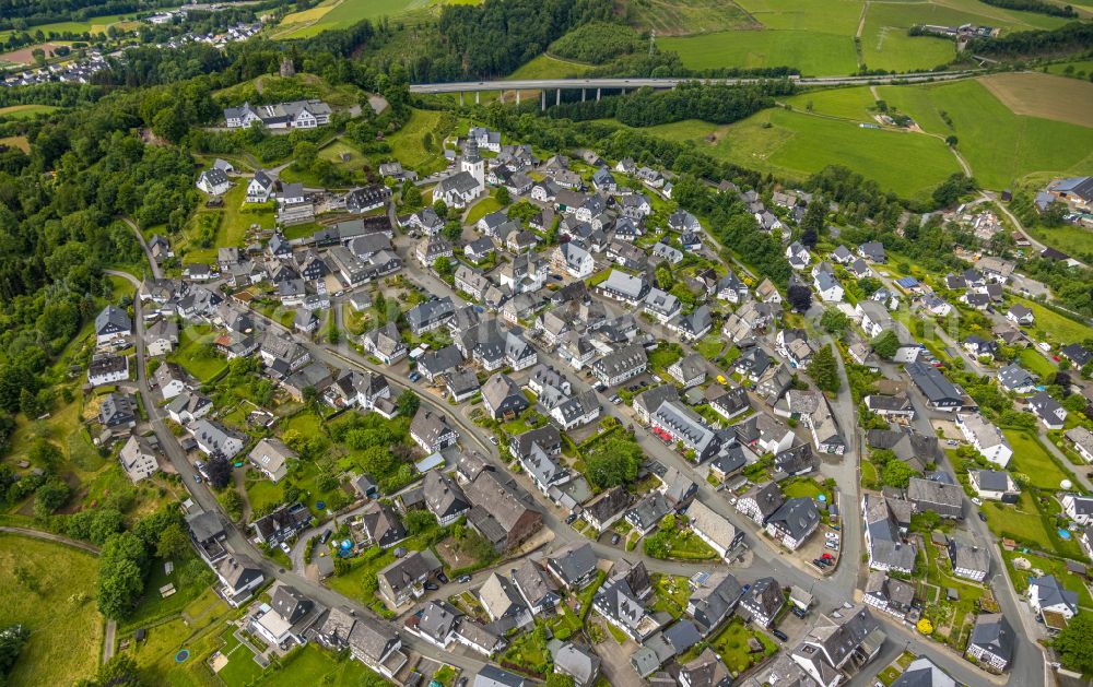 Eversberg from above - Residential areas on the edge of agricultural land in Eversberg at Sauerland in the state North Rhine-Westphalia, Germany
