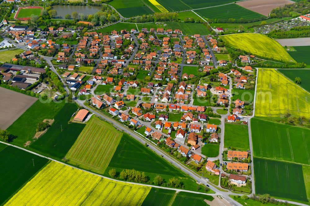 Hellmitzheim from the bird's eye view: Residential areas on the edge of agricultural land in Hellmitzheim in the state Bavaria, Germany