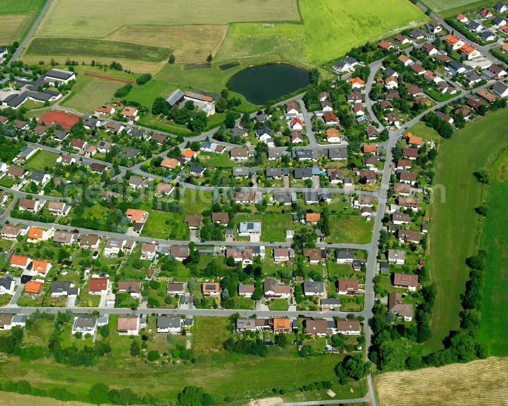 Tauperlitz from the bird's eye view: Residential areas on the edge of agricultural land in Tauperlitz in the state Bavaria, Germany