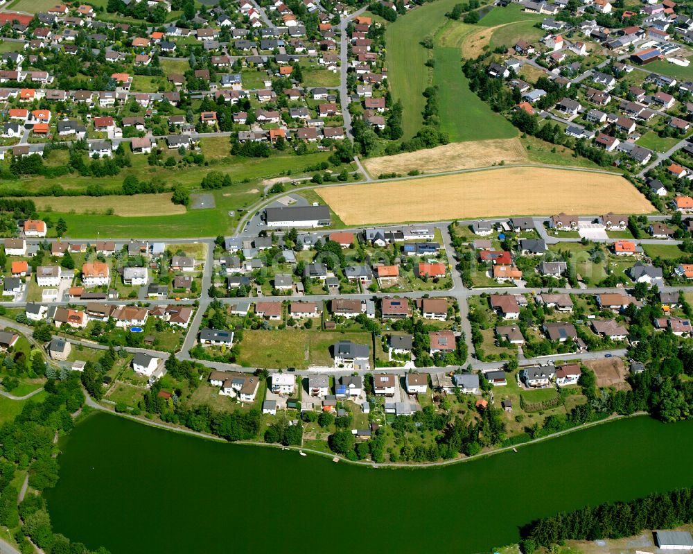 Tauperlitz from the bird's eye view: Residential areas on the edge of agricultural land in Tauperlitz in the state Bavaria, Germany