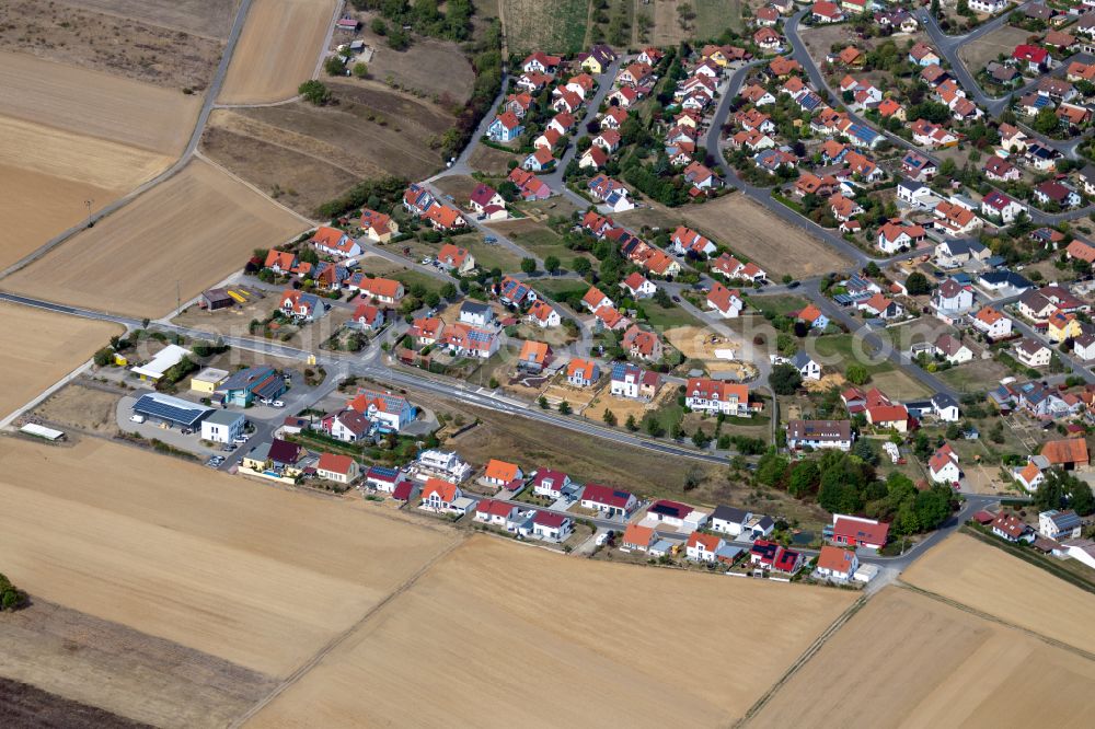 Urspringen from the bird's eye view: Residential areas on the edge of agricultural land in Urspringen in the state Bavaria, Germany