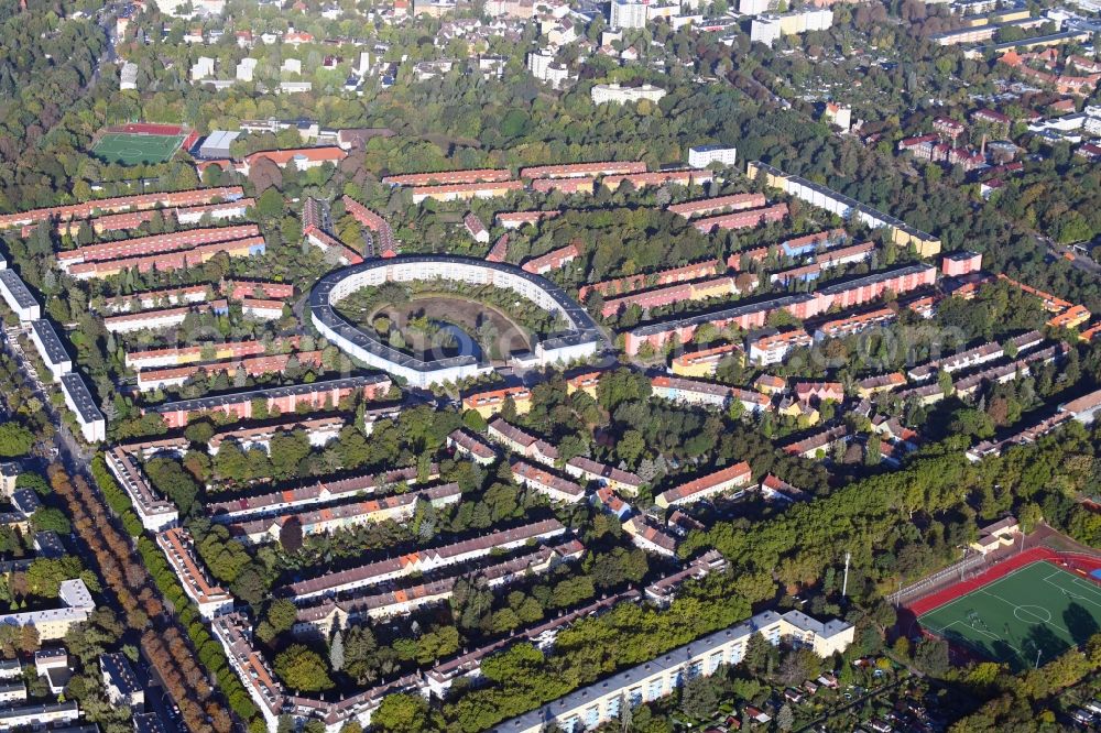 Berlin from above - View of the Horseshoe estate in the Britz part of the district of Neukoelln in Berlin. The Hufeisensiedlung was designed by Bruno Taut and Martin Wagner. It is one of the first projects of social housing and part of the larger settlement Britz - Fritz Reuter city. It is an UNESCO World Heritage Site. The horseshoe itself is still owned by the GEHAG, under the roof of the Deutsche Wohnen AG